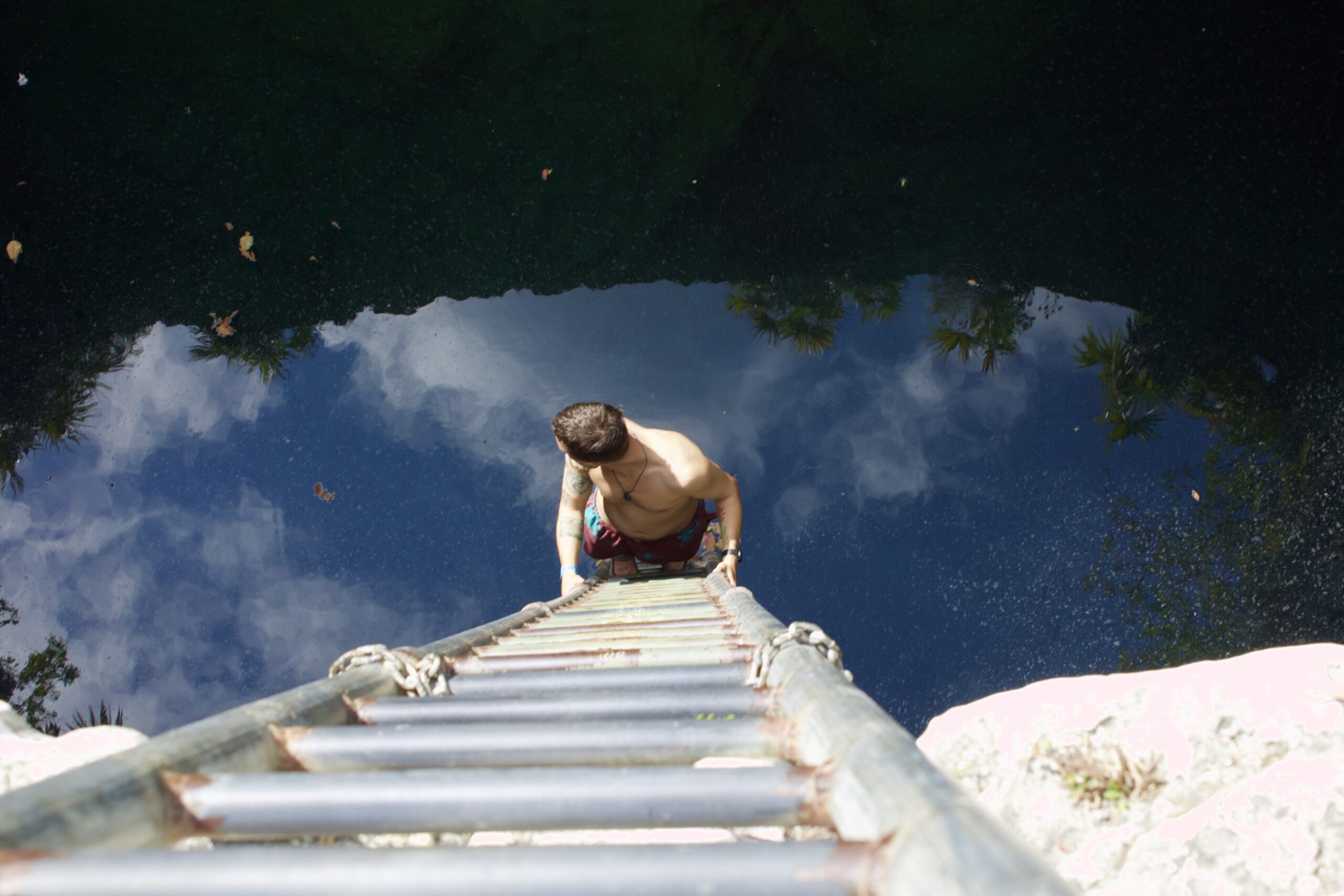 Dylan looking into the deep blue waters of Owl's Hole... hands down one of the coolest things to do in Grand Bahama Island is dive into this blue hole!