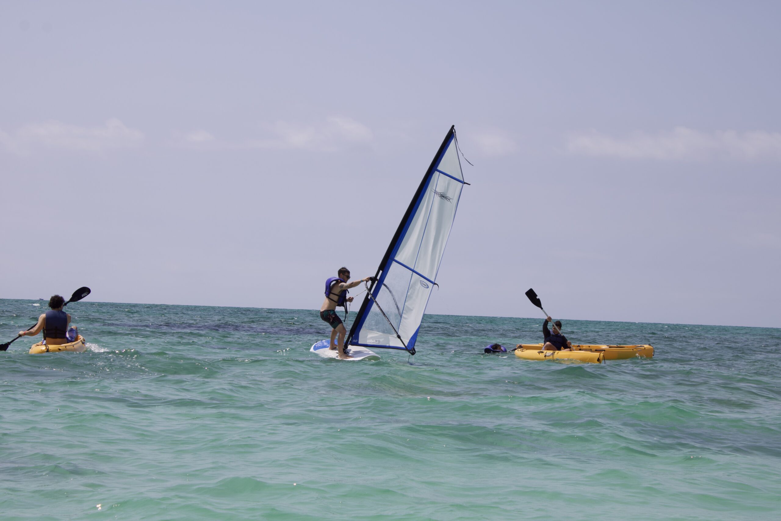 Dylan attempting to wind surf near kayakers off of Fortuna Beach on Grand Bahama Island
